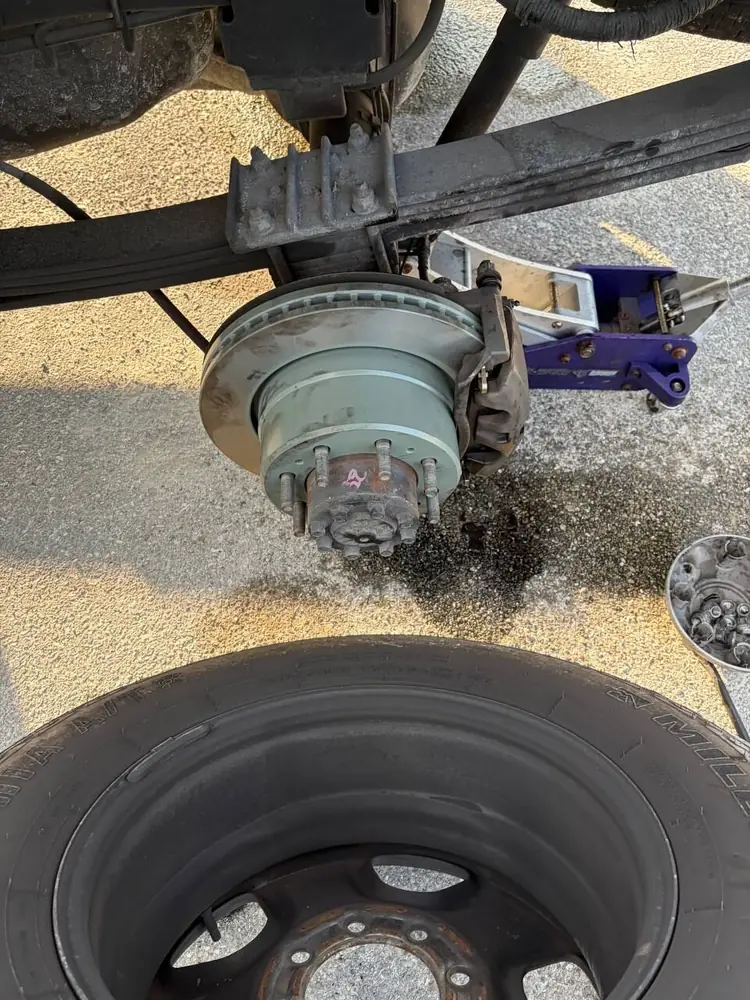 Brake and hub repair close-up with the wheel off during mobile truck service