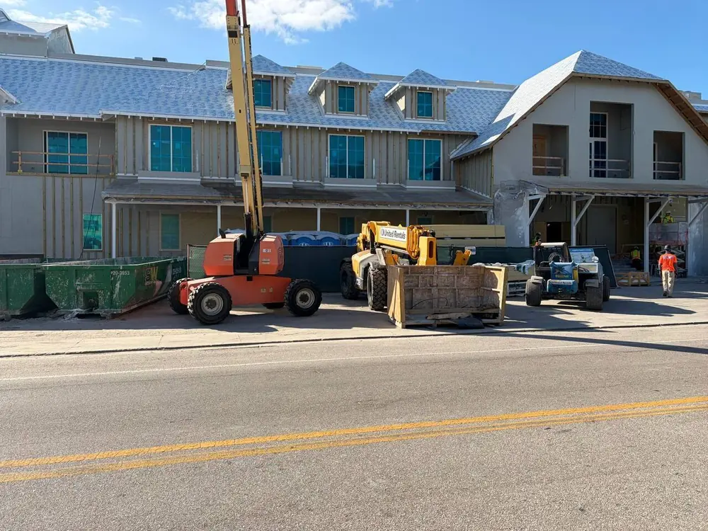 Boom lift and telehandler at a Southwest Florida building site during on-site equipment service