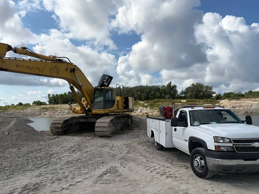 Komatsu excavator and the P&C service truck on a sand mine jobsite in Southwest Florida