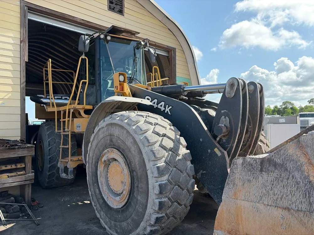 John Deere 844K wheel loader at the shop door for heavy equipment repair