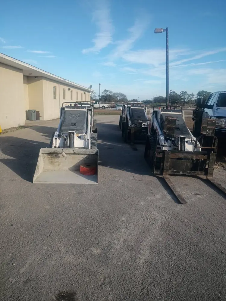 Bobcat skid steers lined up for fleet service in a Southwest Florida yard