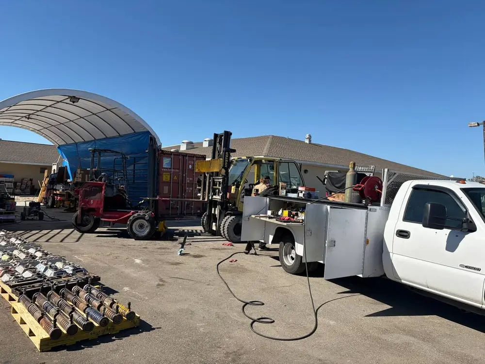 P&C service truck and forklift in a working equipment yard between repairs