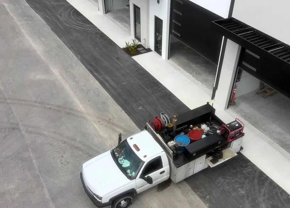 The P&C service truck parked at a commercial building, seen from above