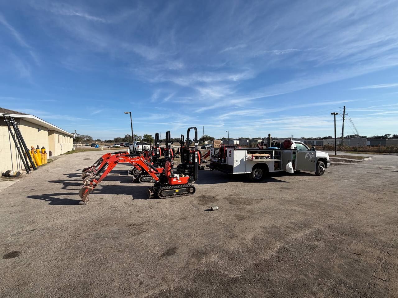 Excavators and a service truck staged in a Southwest Florida equipment yard served by P&C Mobile Repair